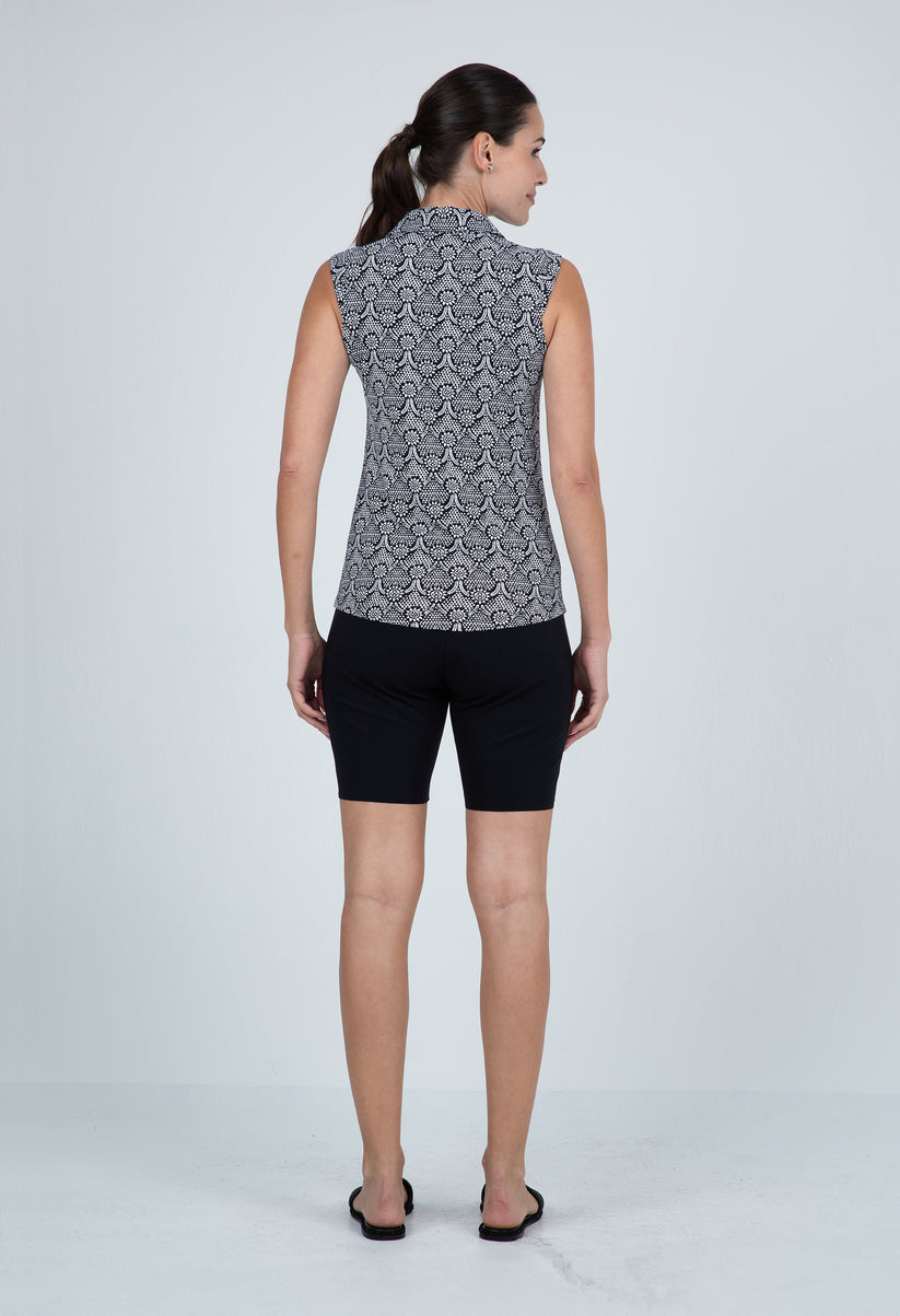 Black and gray patterned sleeveless top with a high collar.