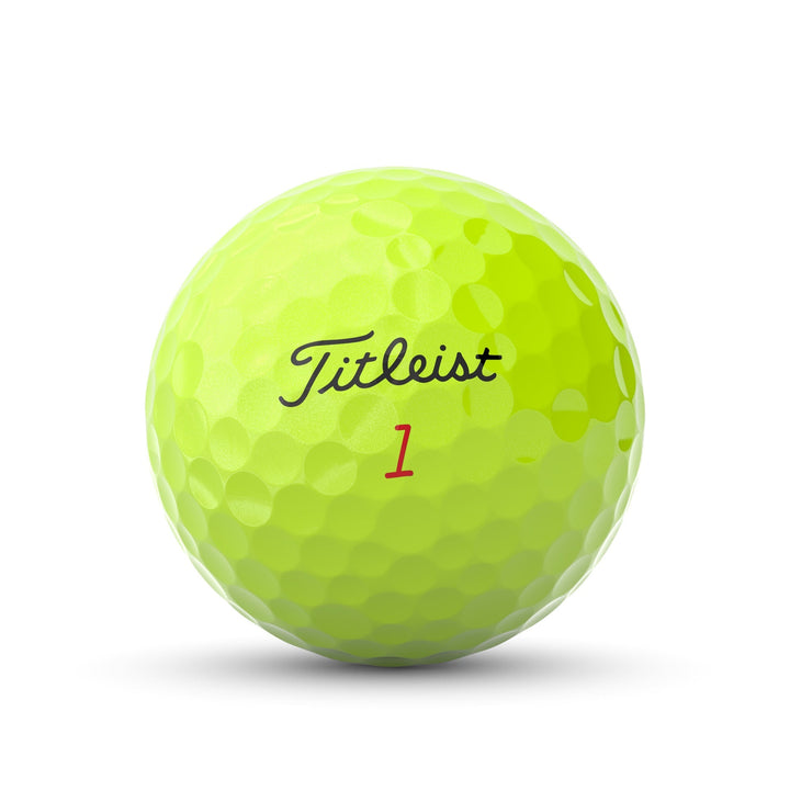 Yellow titleist golf ball with dimpled surface and number ’1’’ in red.
