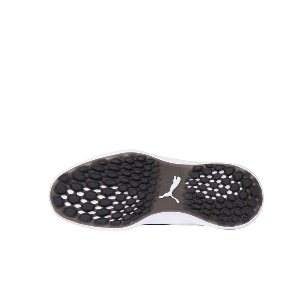 Black and white puma golf shoe with textured sole design.