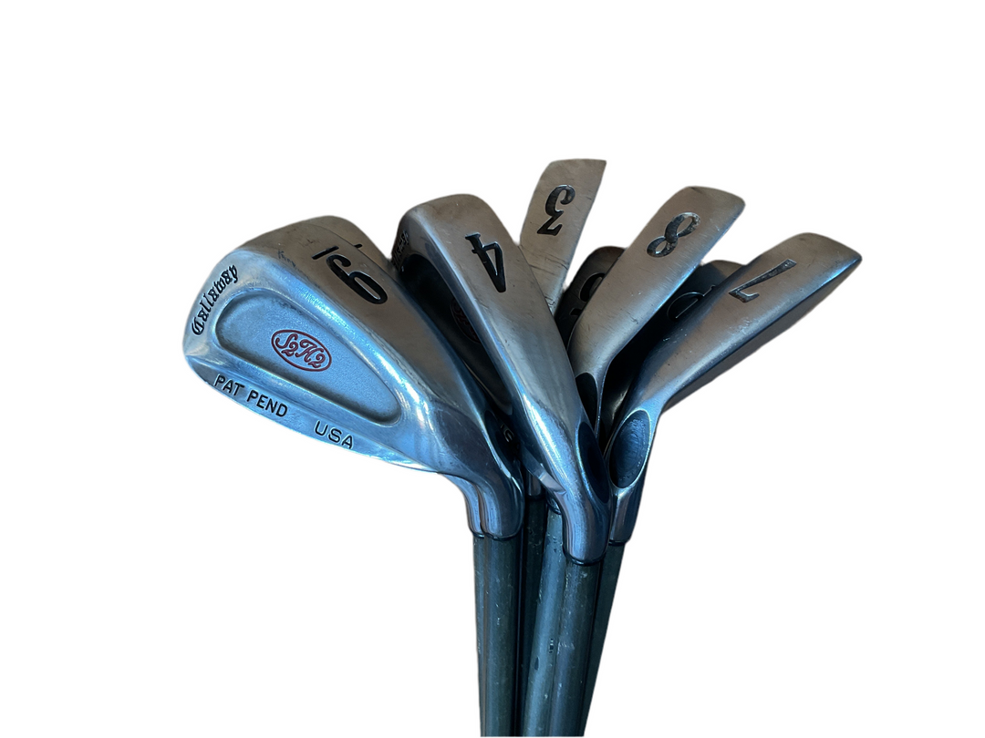4-iron golf club with black and silver finish, featuring a ’golf pride’ grip.