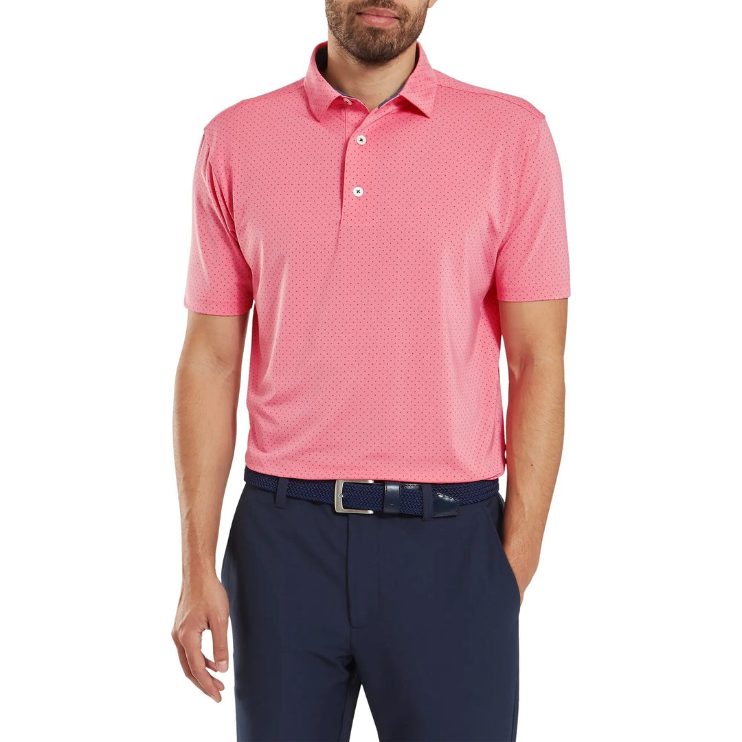 Coral polo shirt with perforated design and button-down collar, likely made of polyester or cotton blend.