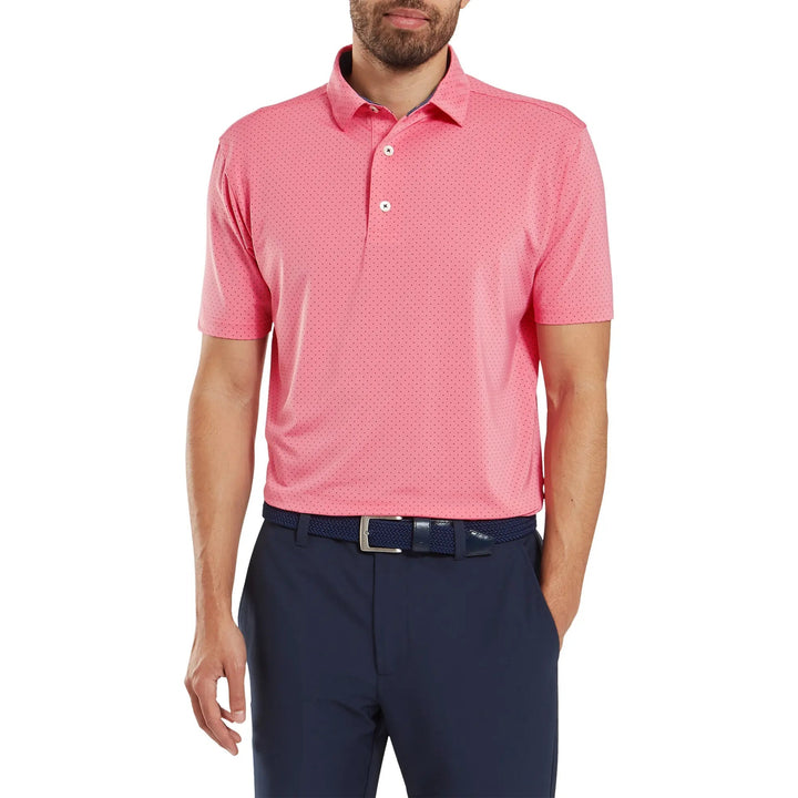 Coral polo shirt with perforated design and button-down collar, likely made of polyester or cotton blend.