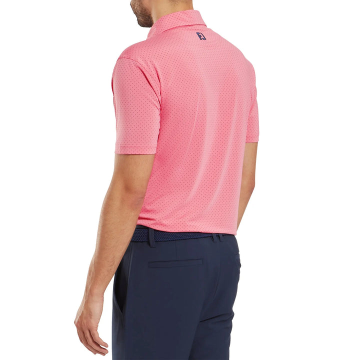 Pink golf polo shirt with a subtle pattern and logo on the back, made of breathable fabric.