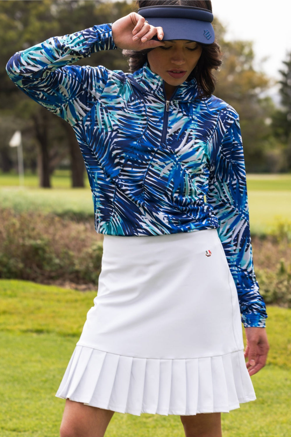 White pleated Ladies Harper Skort golf skirt with button closure and logo