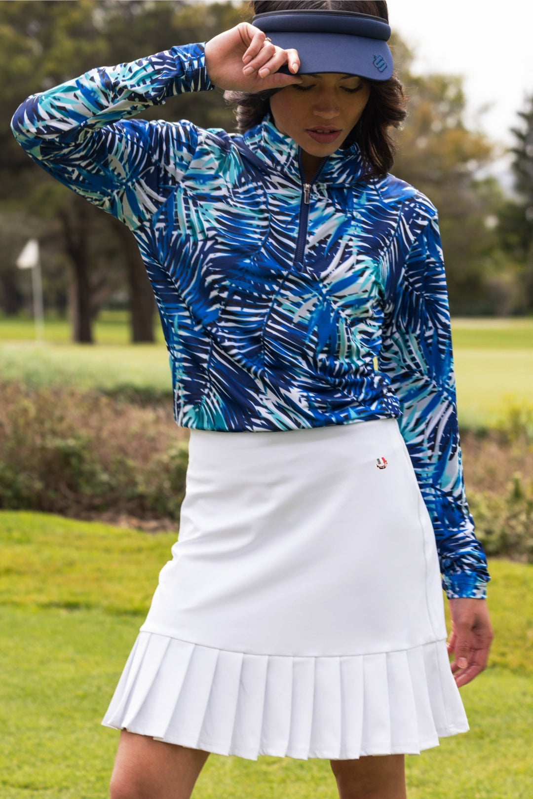 White pleated Ladies Harper Skort golf skirt with button closure and logo