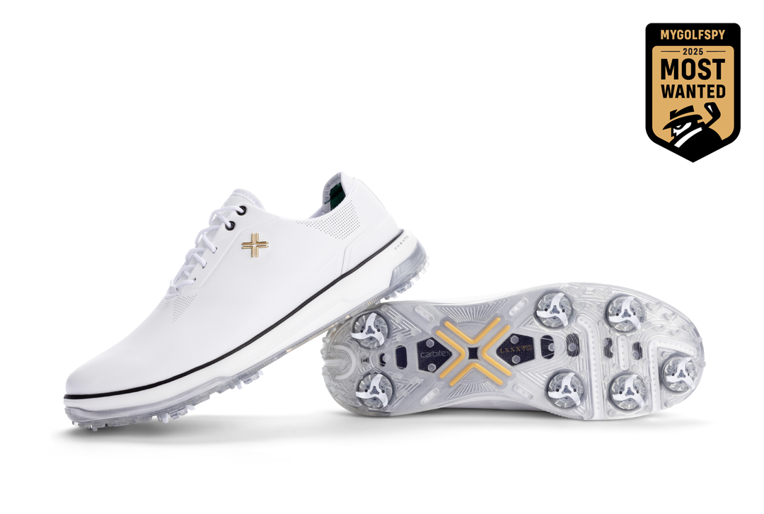 White leather golf shoe with gold accents and spike design.