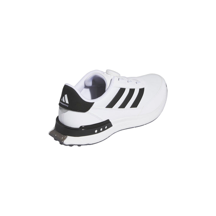 White and black adidas golf shoe with spikes.
