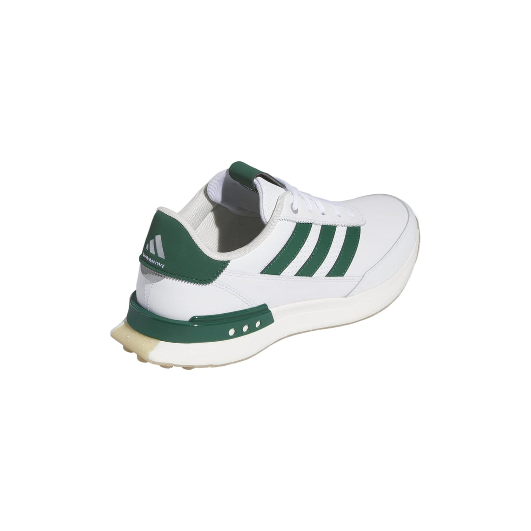 White and green adidas cricket shoe with textured sole.