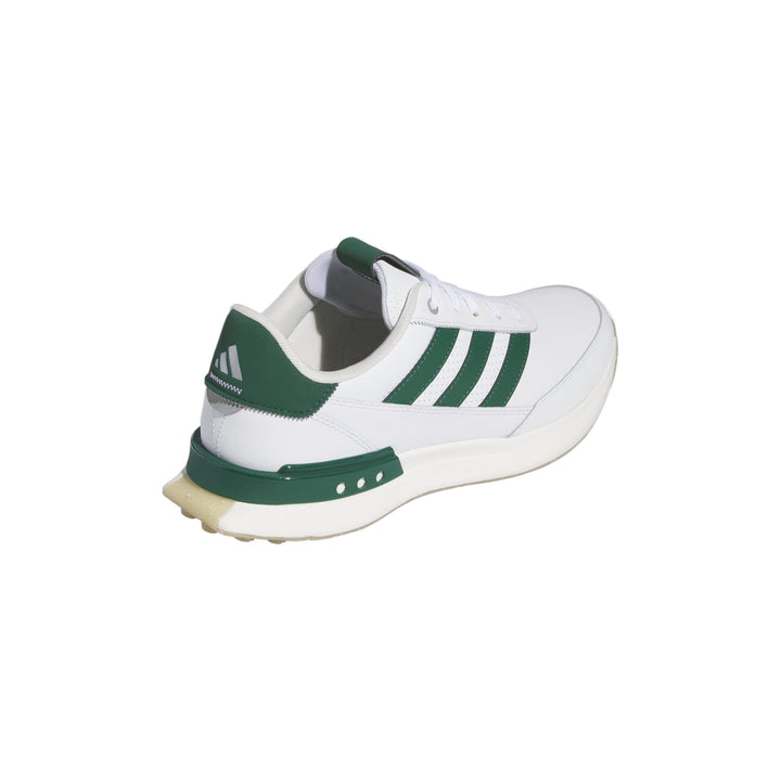 White and green adidas cricket shoe with textured sole.