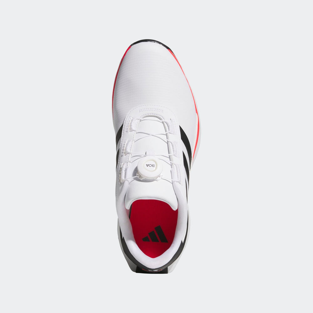 White and black adidas sneaker with red sole, designed for athletic performance.