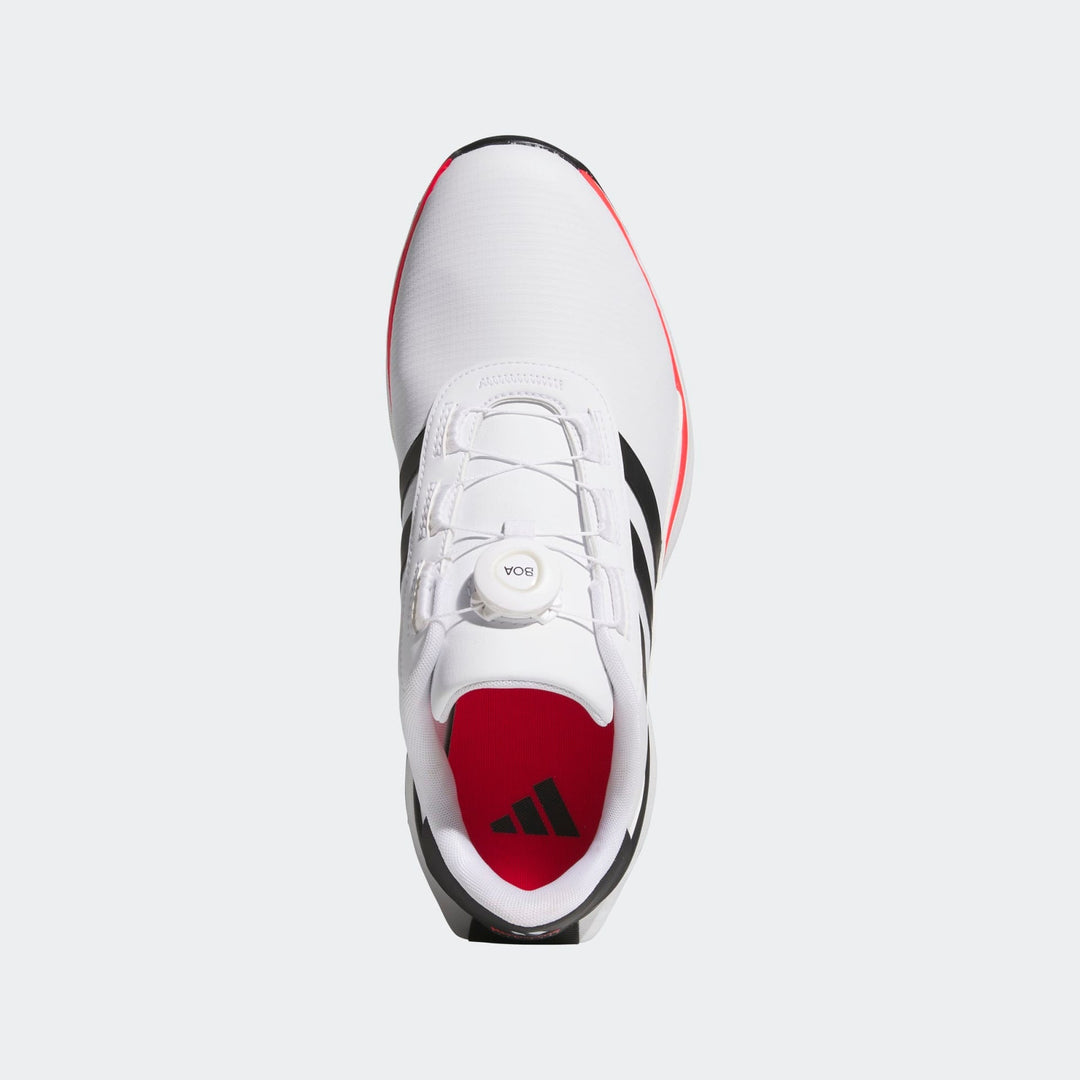 White and black adidas sneaker with red sole, designed for athletic performance.