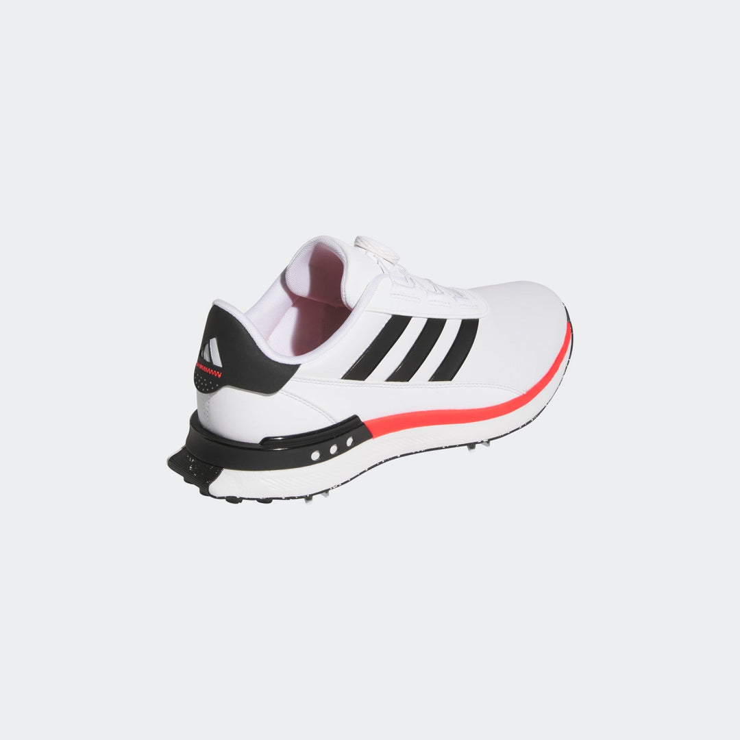 Adidas white and black golf shoe with red accents.
