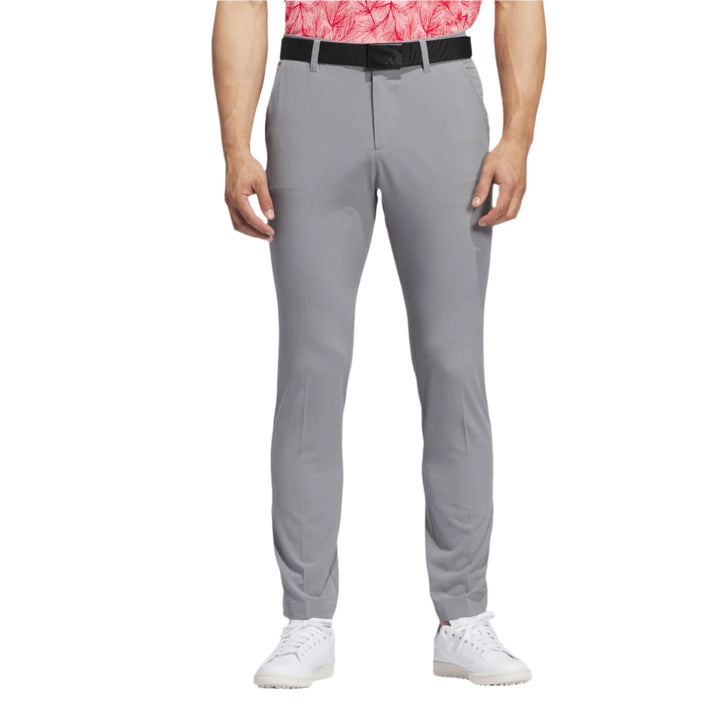 Grey golf pants with black belt and white shoes, nike brand.