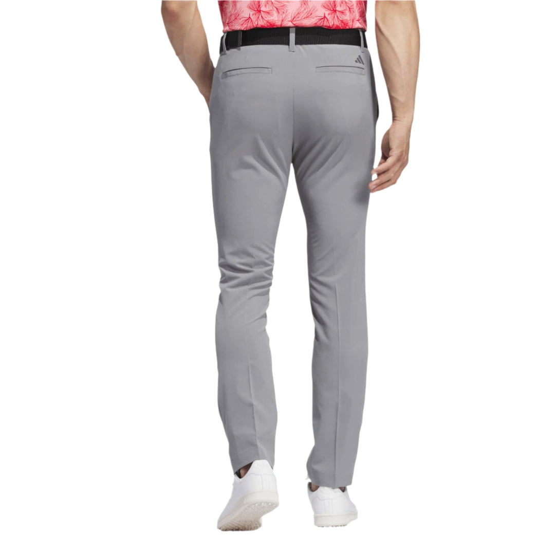 Gray slim fit golf pants with white stripes and adidas branding.