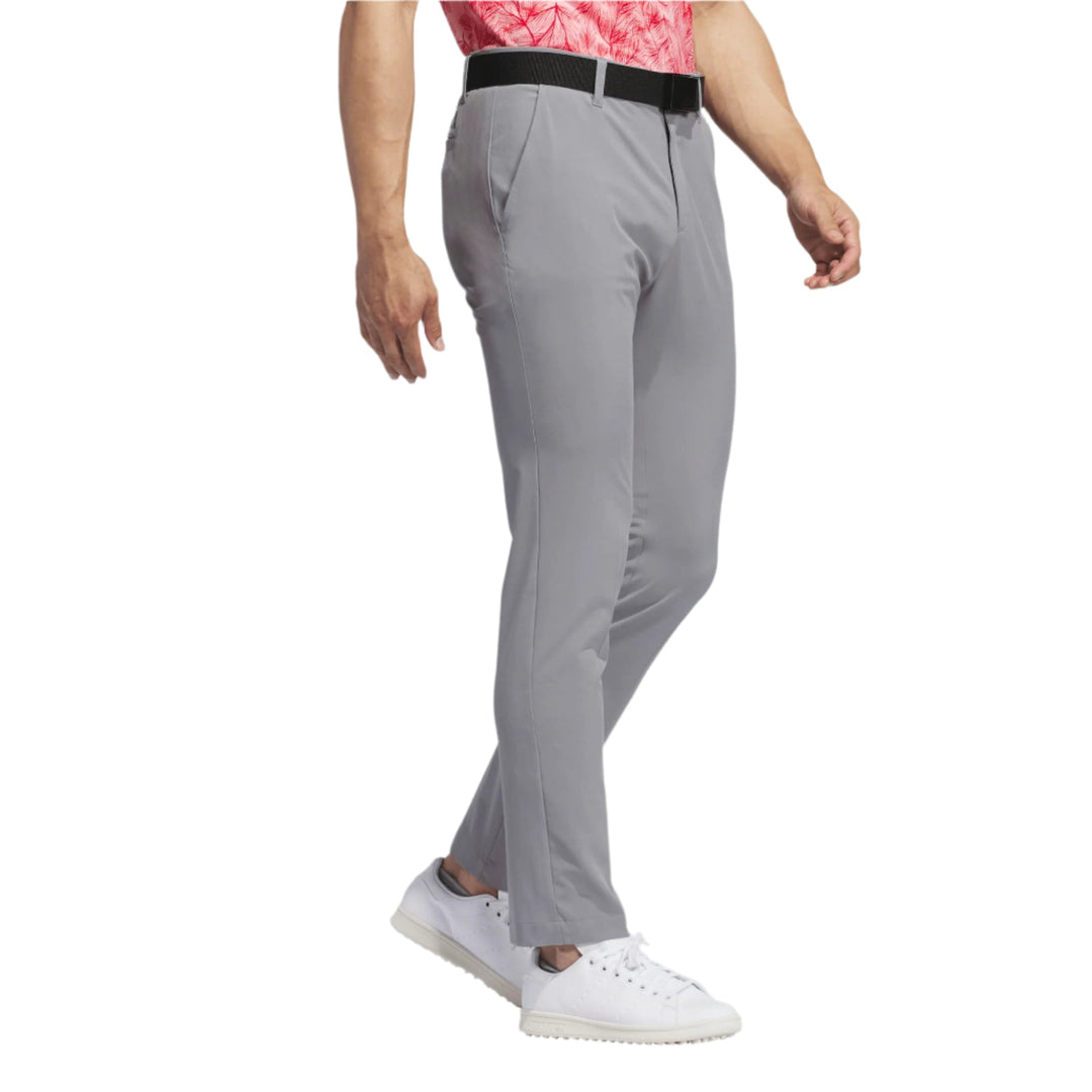 Nike golf tech pants, light gray with black waistband and white sneakers.