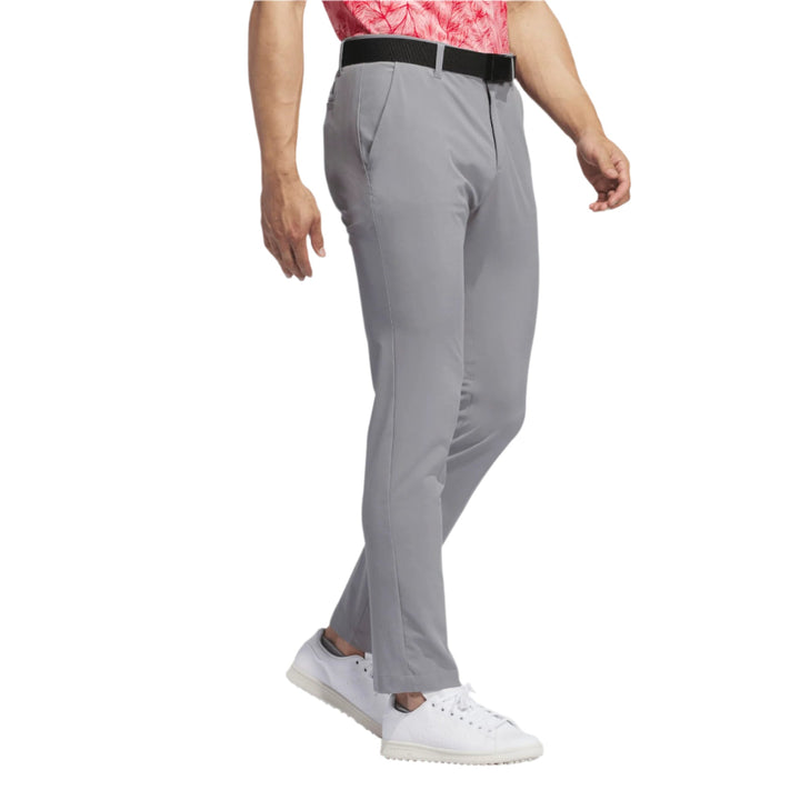 Nike golf tech pants, light gray with black waistband and white sneakers.