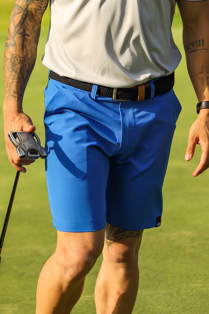 Royal blue golf shorts with black belt and white shirt.