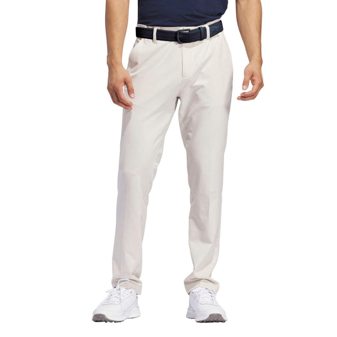 Light beige golf pants with a sleek design and stretch material for comfort.