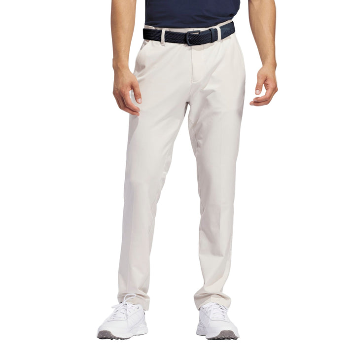 Light beige golf pants with a sleek design and stretch material for comfort.