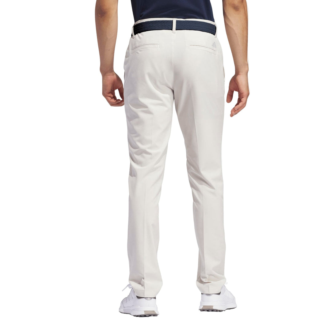 White golf pants with a belt loop and elastic waistband, likely made of cotton or polyester blend.