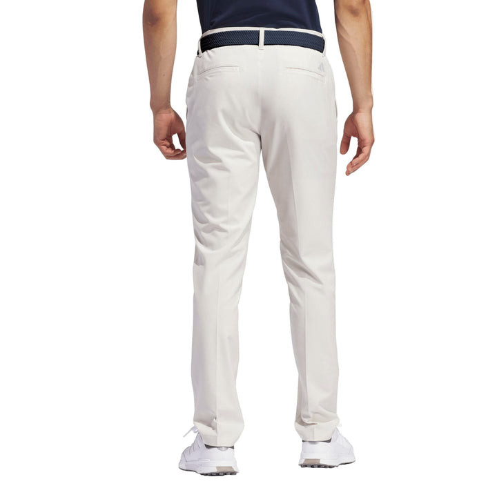 White golf pants with a belt loop and elastic waistband, likely made of cotton or polyester blend.