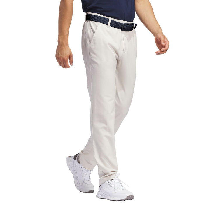 Light gray golf pants with pleats and a belt loop, likely made of polyester or cotton blend.