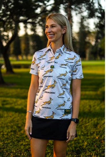 White polo shirt with short sleeves and all-over print of yellow birds, black skirt.