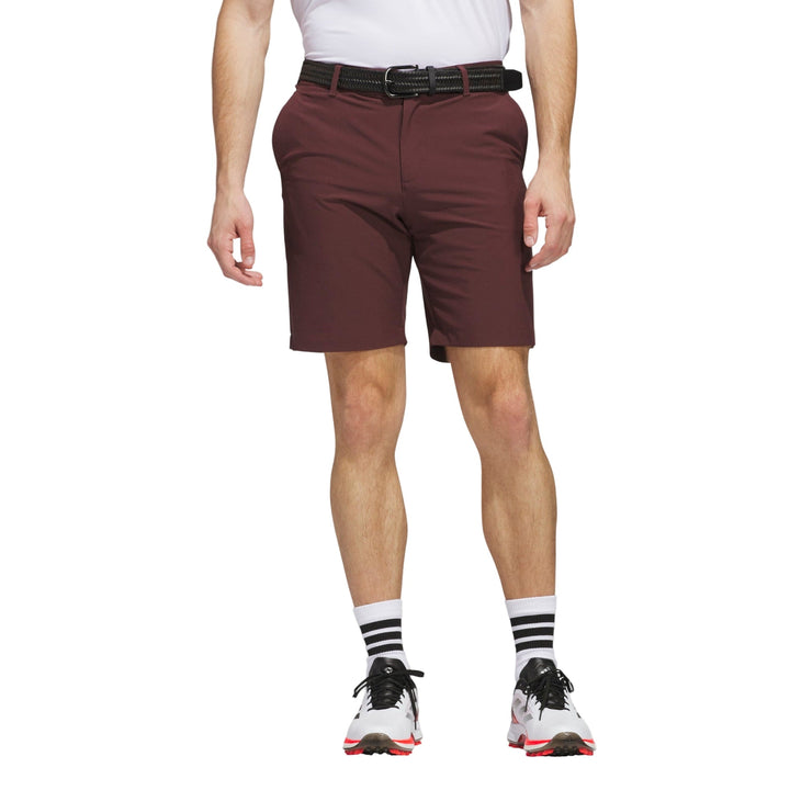 Maroon golf shorts with belt loop and white stripe on socks.