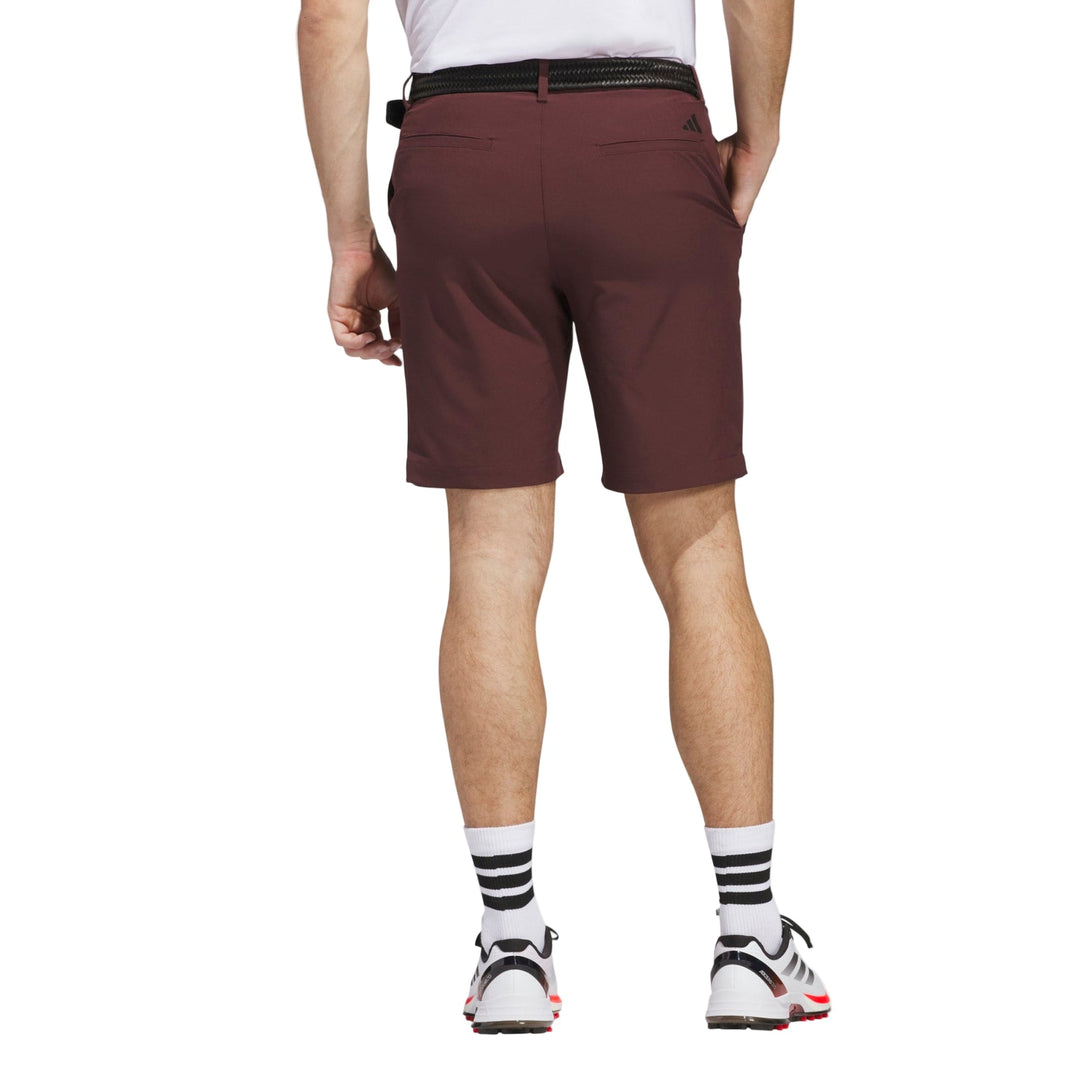 Maroon golf shorts with black belt and white socks, adidas brand.