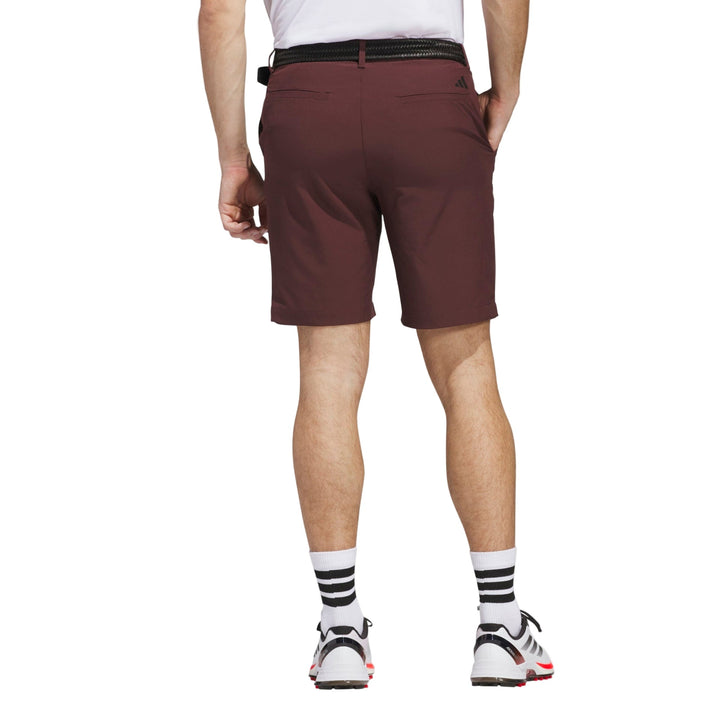 Maroon golf shorts with black belt and white socks, adidas brand.