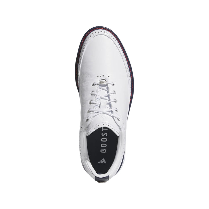 White leather golf shoe with boost cushioning and laces.