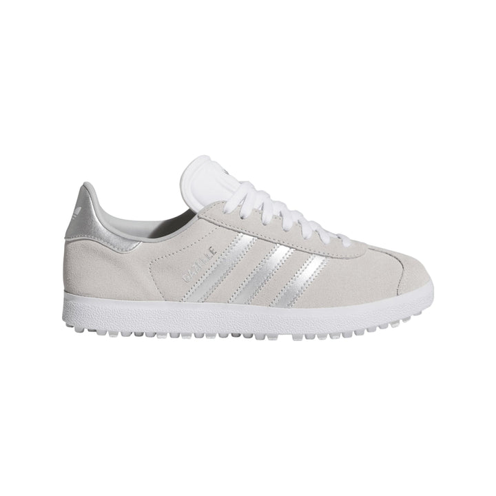 Silver adidas gazelle sneakers with white stripes and rubber soles.