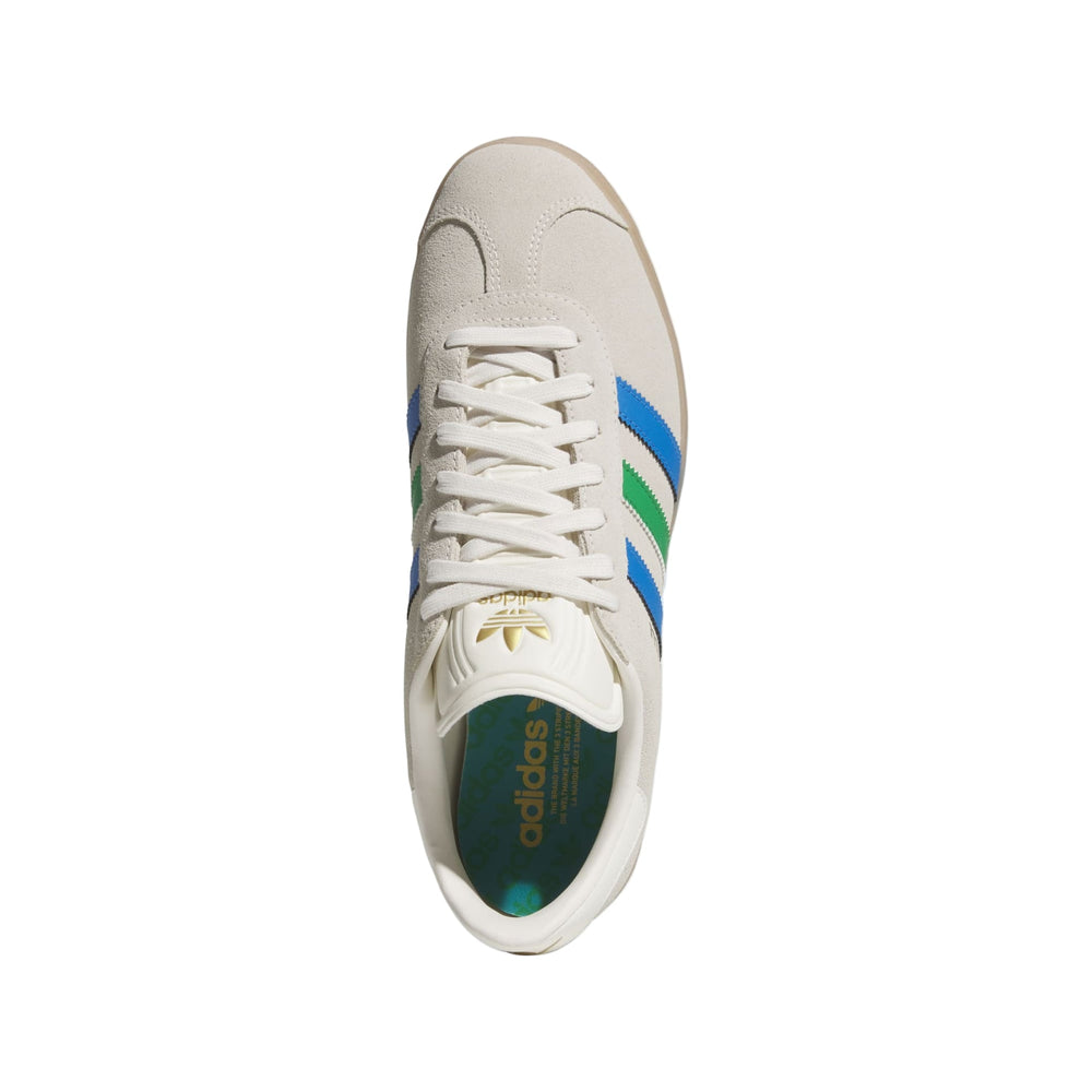 Adidas gazelle sneakers in white with blue and green stripes.