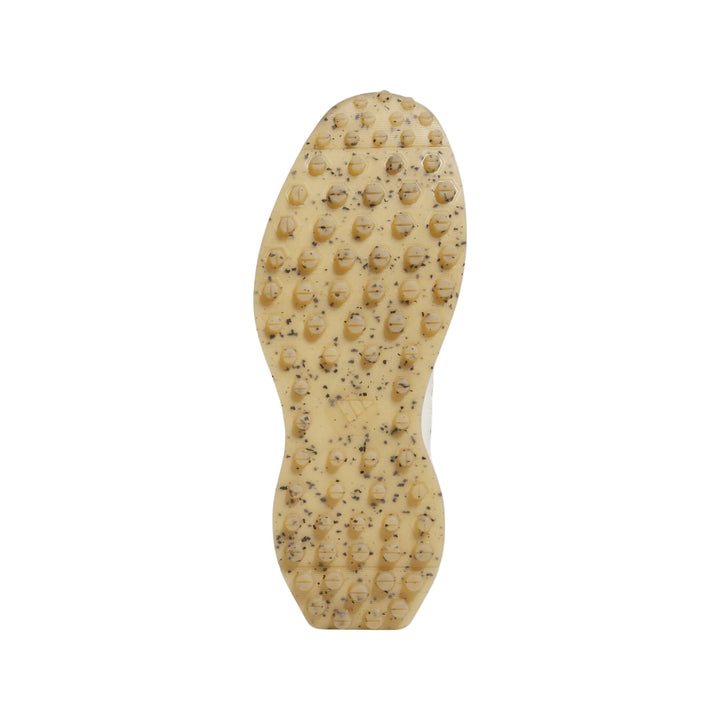 Tan textured rubber sole with small spikes for grip and durability.