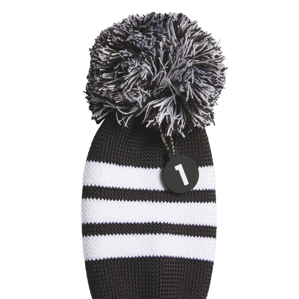 Black and white striped knit golf club head cover with pom-pom accent, number 1 tag.