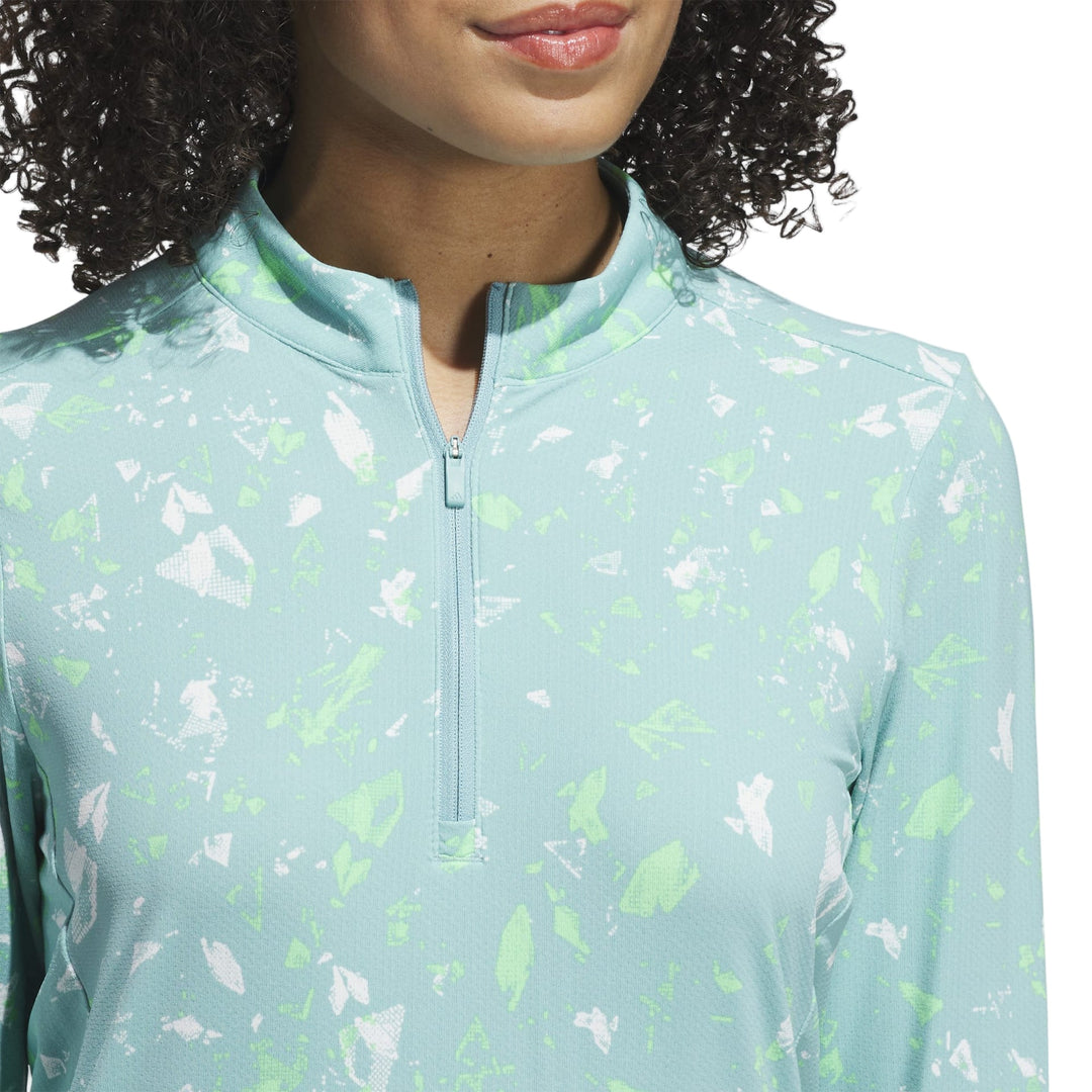 Mint green floral print zip-up jacket with a half-zip closure and stand collar.