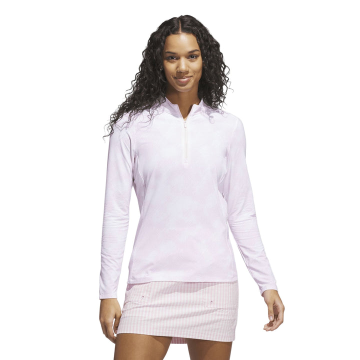 White long-sleeved pullover with zipper detail and ribbed skirt.