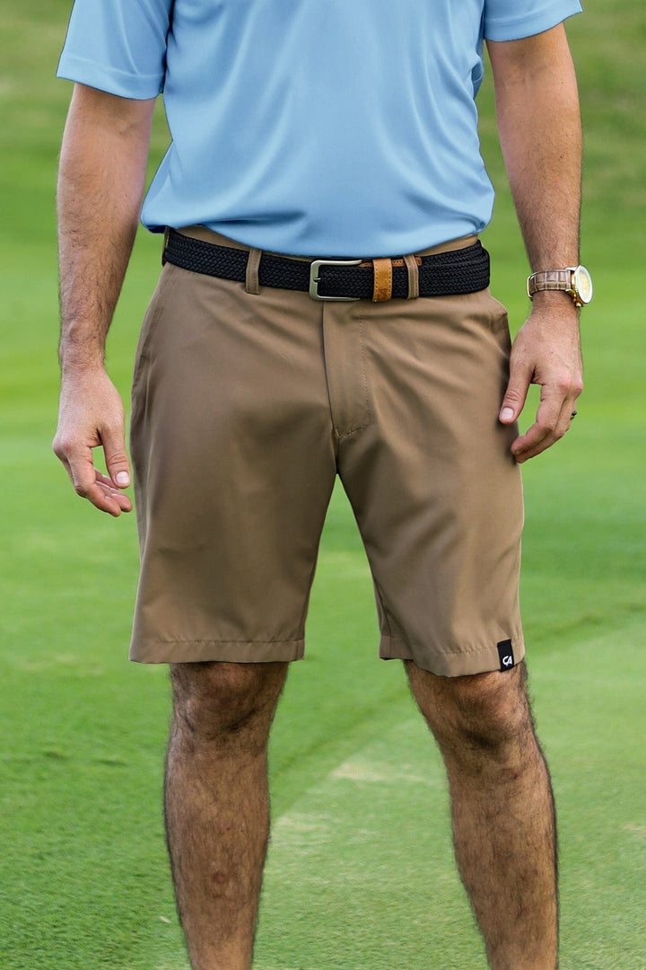 Khaki golf shorts with black belt and brown buckle, likely from a popular outdoor apparel brand.