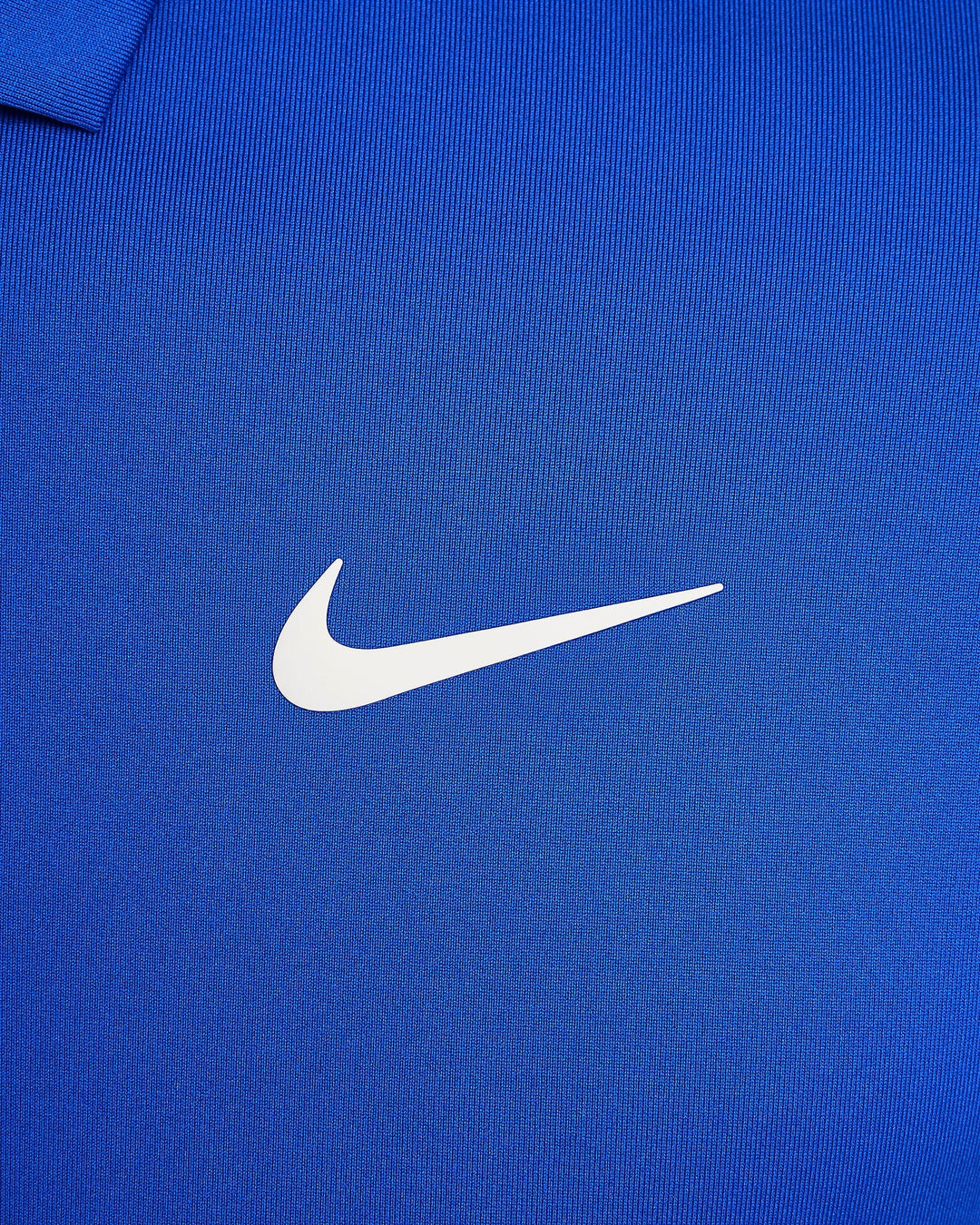 Nike swoosh logo on blue fabric.