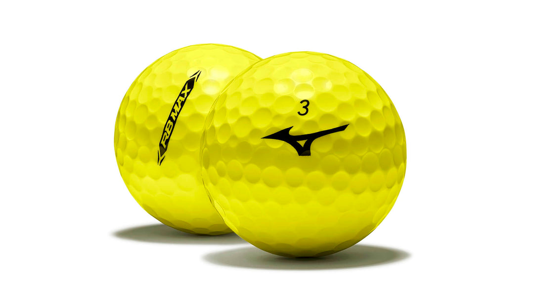 Yellow mizuno golf ball with dimpled surface and number 3 on it.