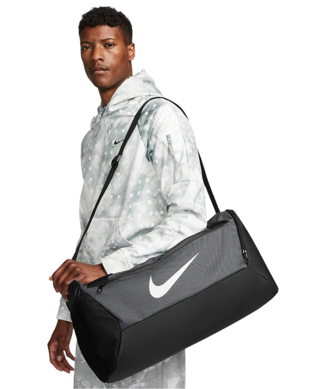 Black nike duffel bag with white swoosh logo and adjustable shoulder strap.