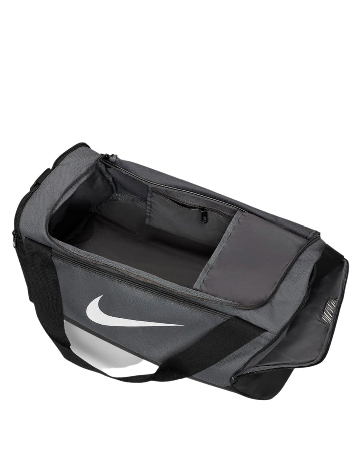 Nike duffel bag with black and white color scheme, featuring a large swoosh logo on the front.