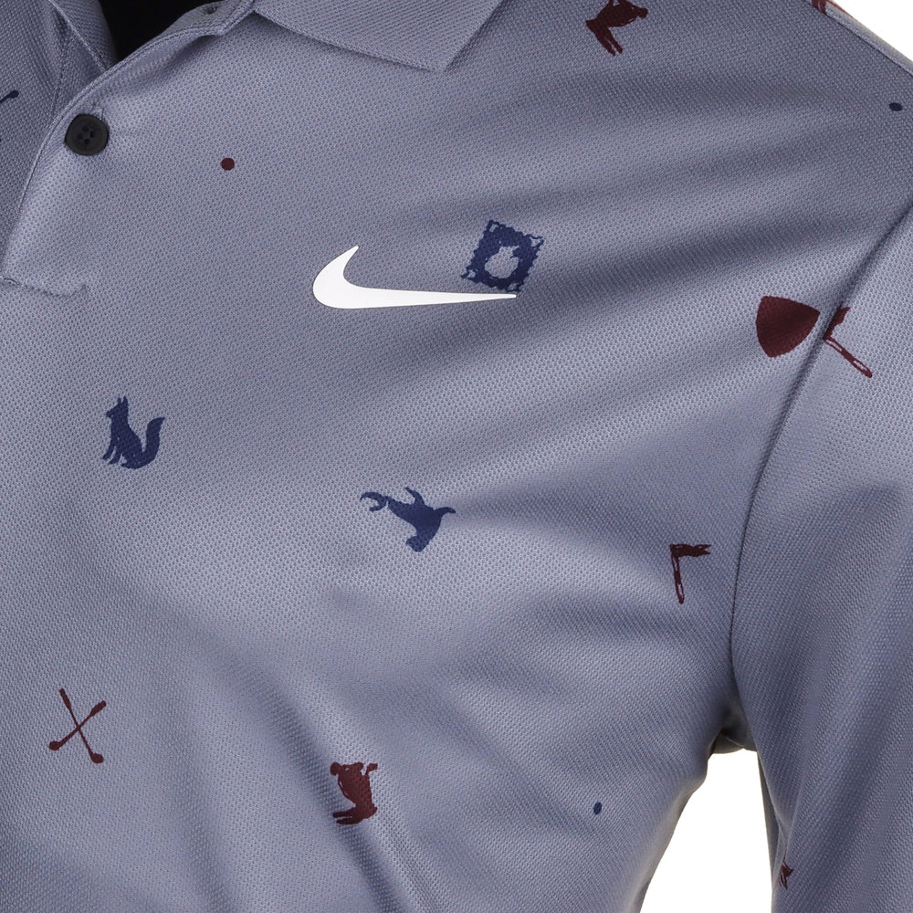Nike polo shirt with animal and golf club prints, gray background.
