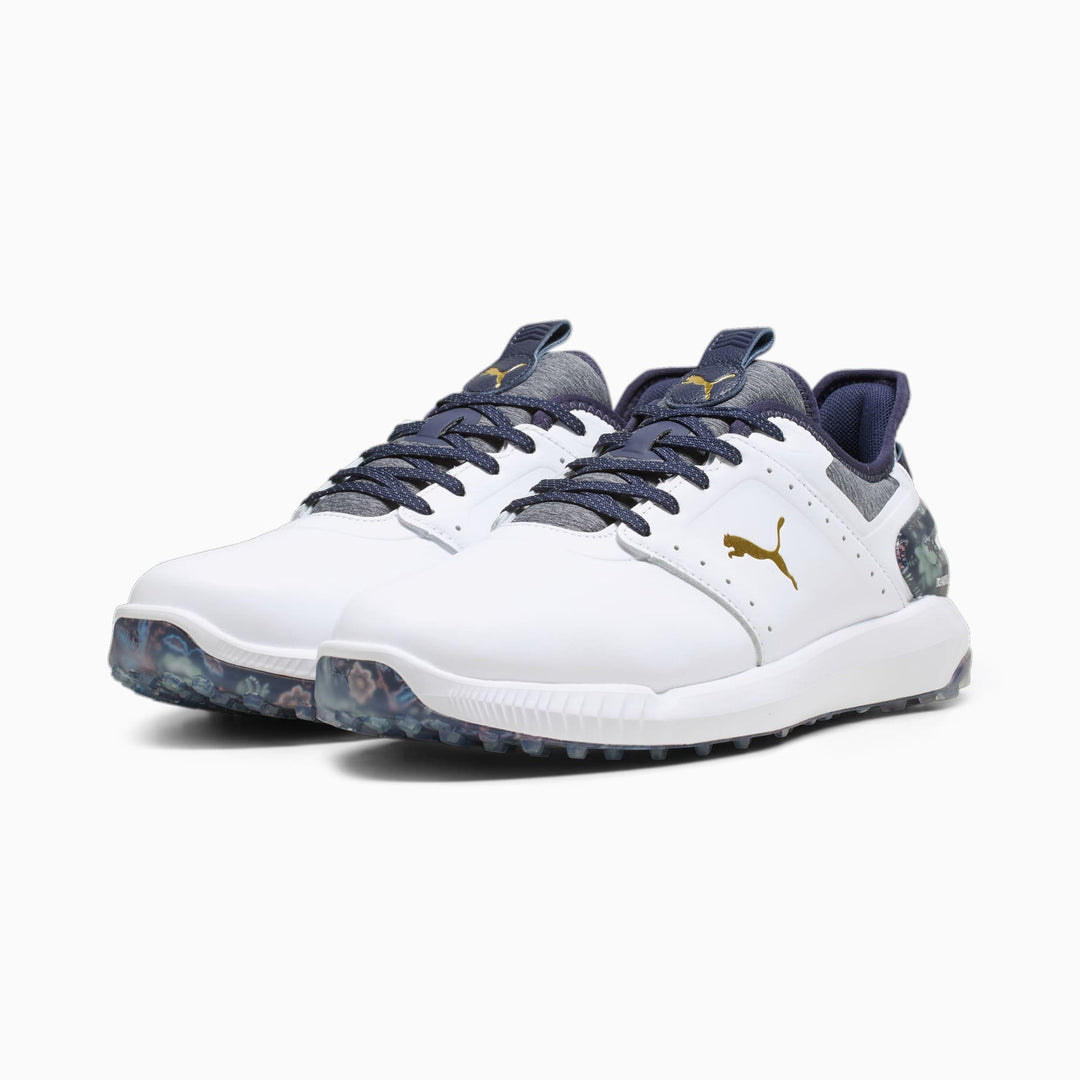 White and navy blue puma golf shoe with textured upper, rubber sole, and branding.