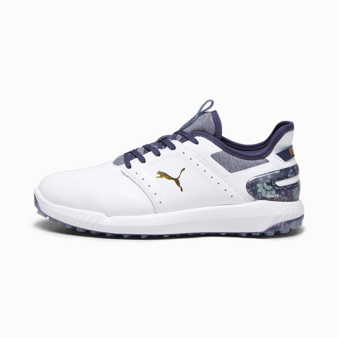 White puma golf shoe with navy blue accents and gold details.