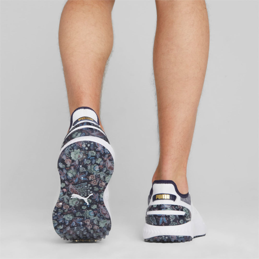 Puma women’s golf shoes with floral pattern and white accents.
