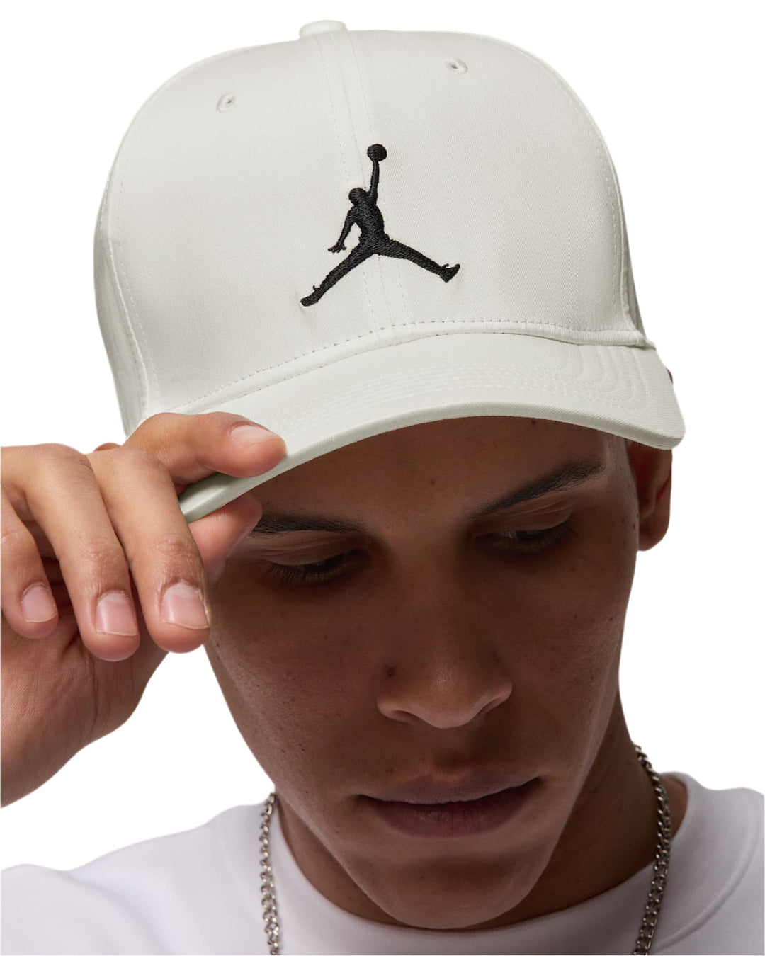White jordan brand baseball cap with black jumpman logo.