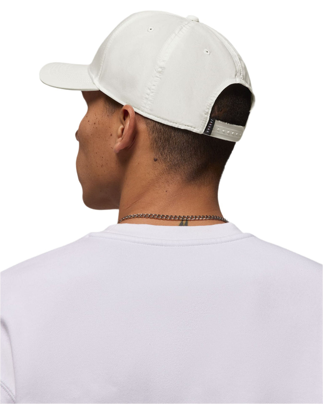 White baseball cap with black strap and logo, likely adidas model.