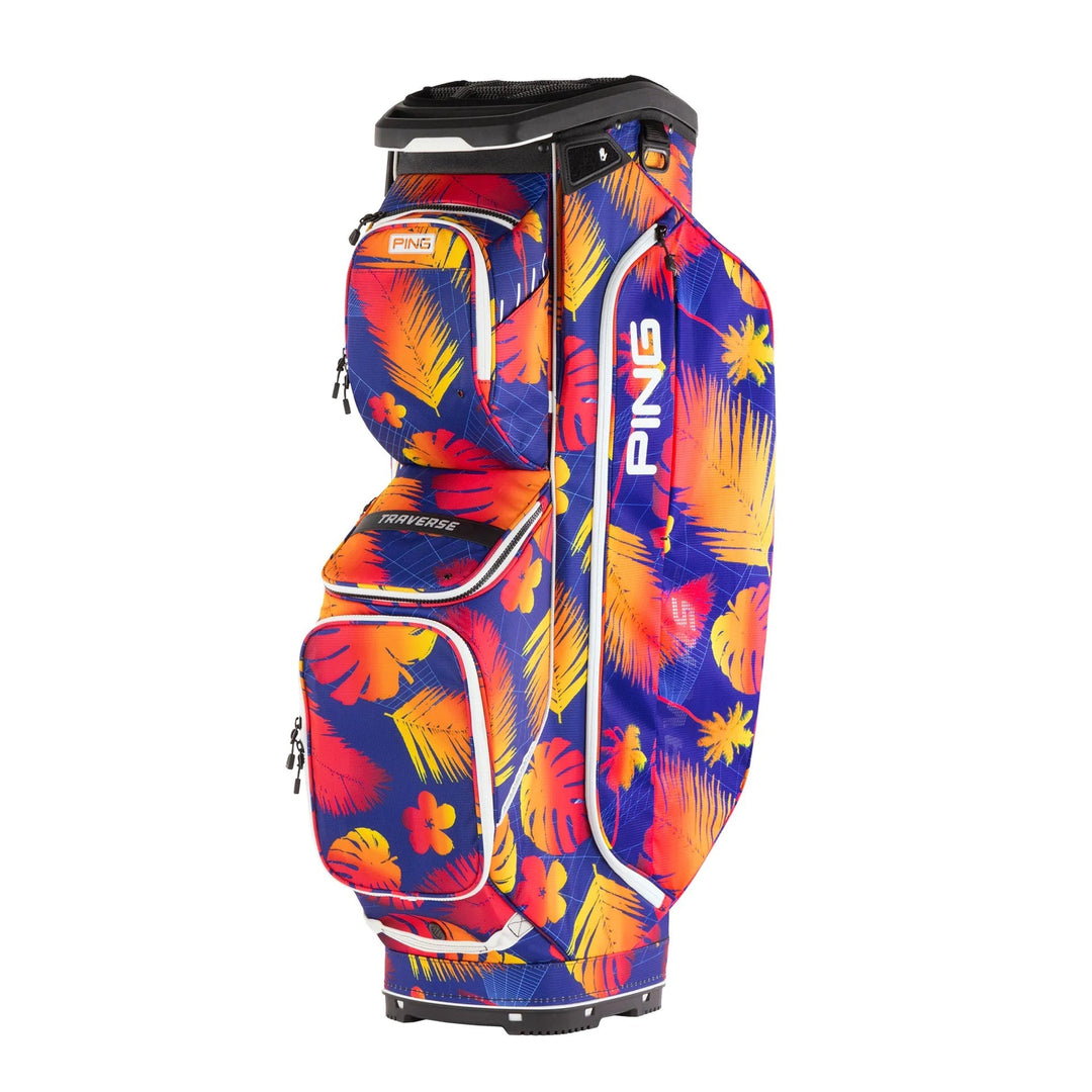 Ping golf bag with vibrant tropical leaf pattern, featuring durable fabric and sturdy wheels.