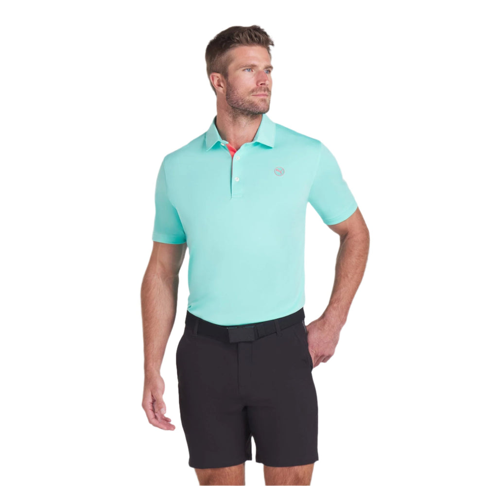 Teal polo shirt with contrast stitching and collar, made of cotton blend material.
